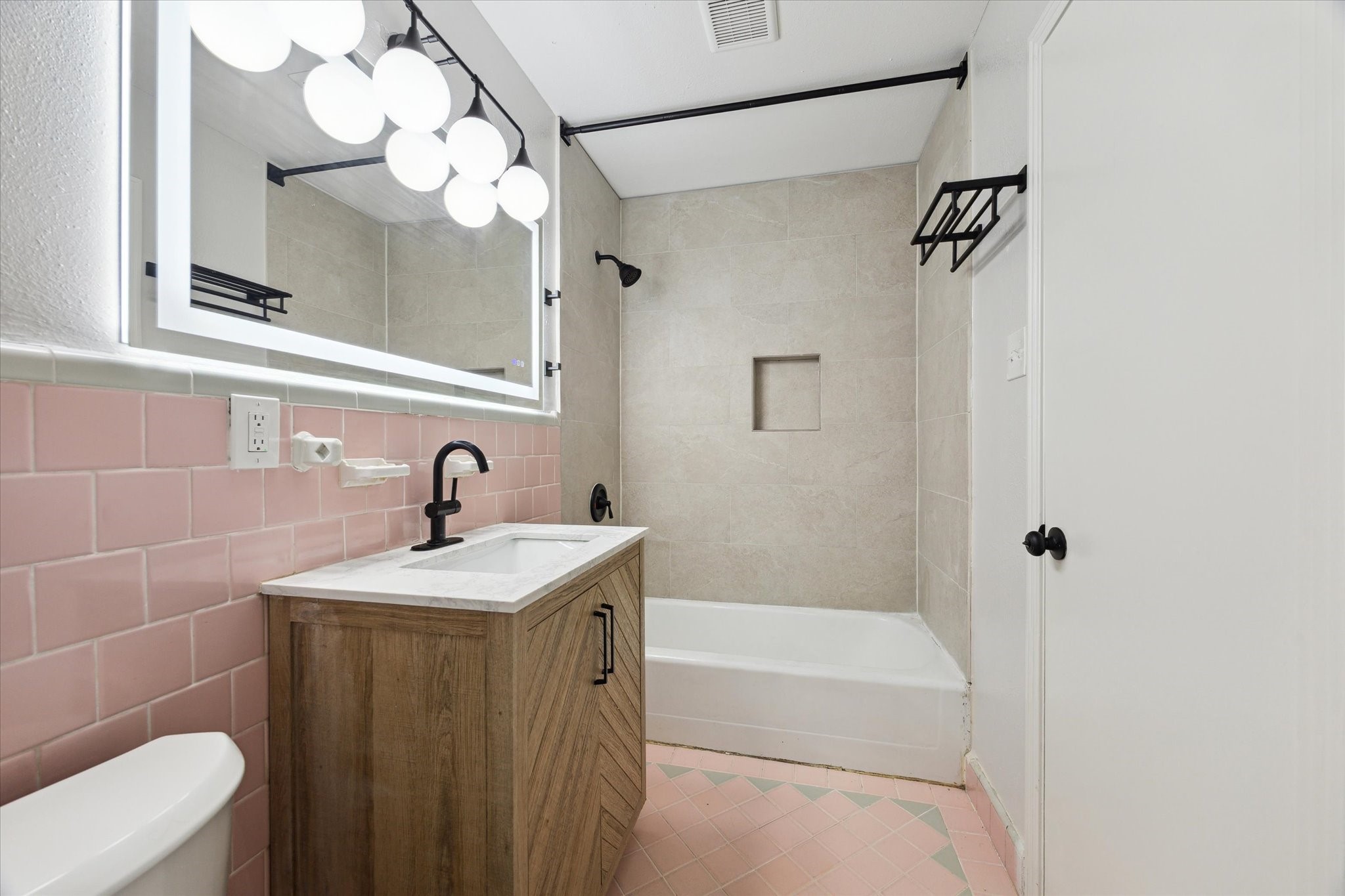 522 Barkley Street Houston, TX 77022 - Photo 8 of 18 The en-suite bath enjoyed by the primary bedroom is a great blend of vintage and contemporary design.