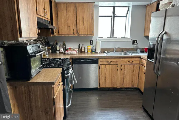 a kitchen with a sink stove and refrigerator