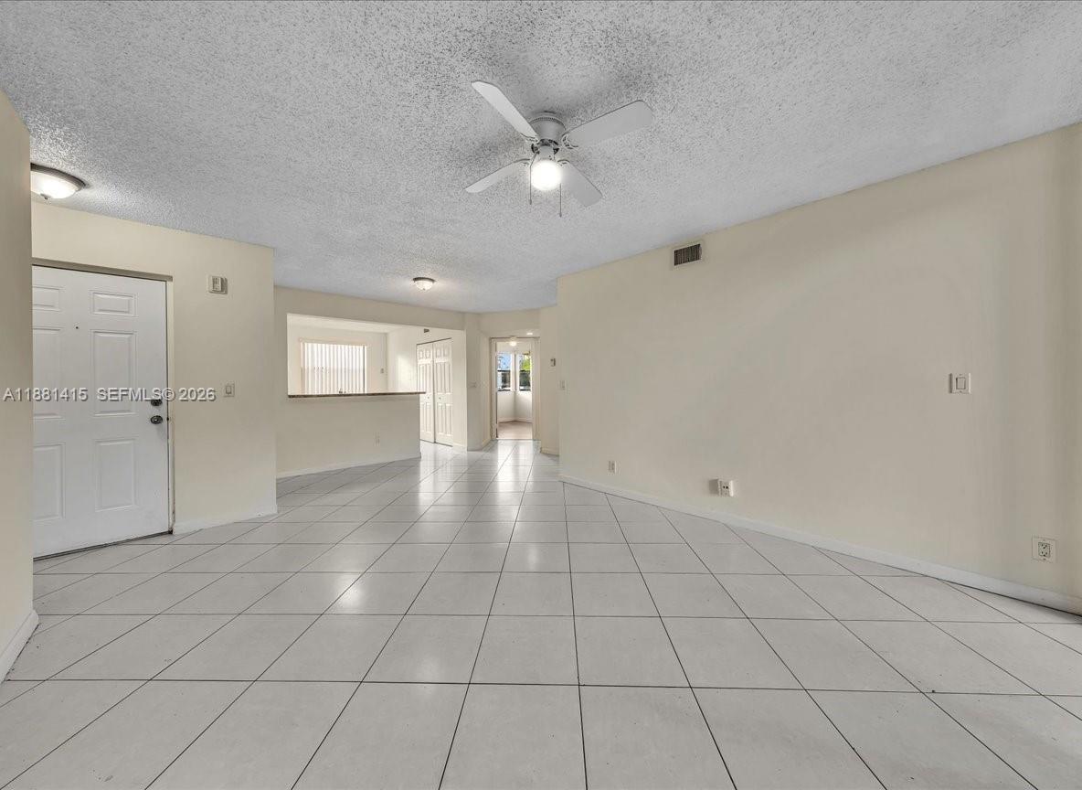 5661 Riverside Drive, Unit 101B7 Coral Springs, FL 33067 - Photo 11 of 49 wooden floor in an empty room with a window