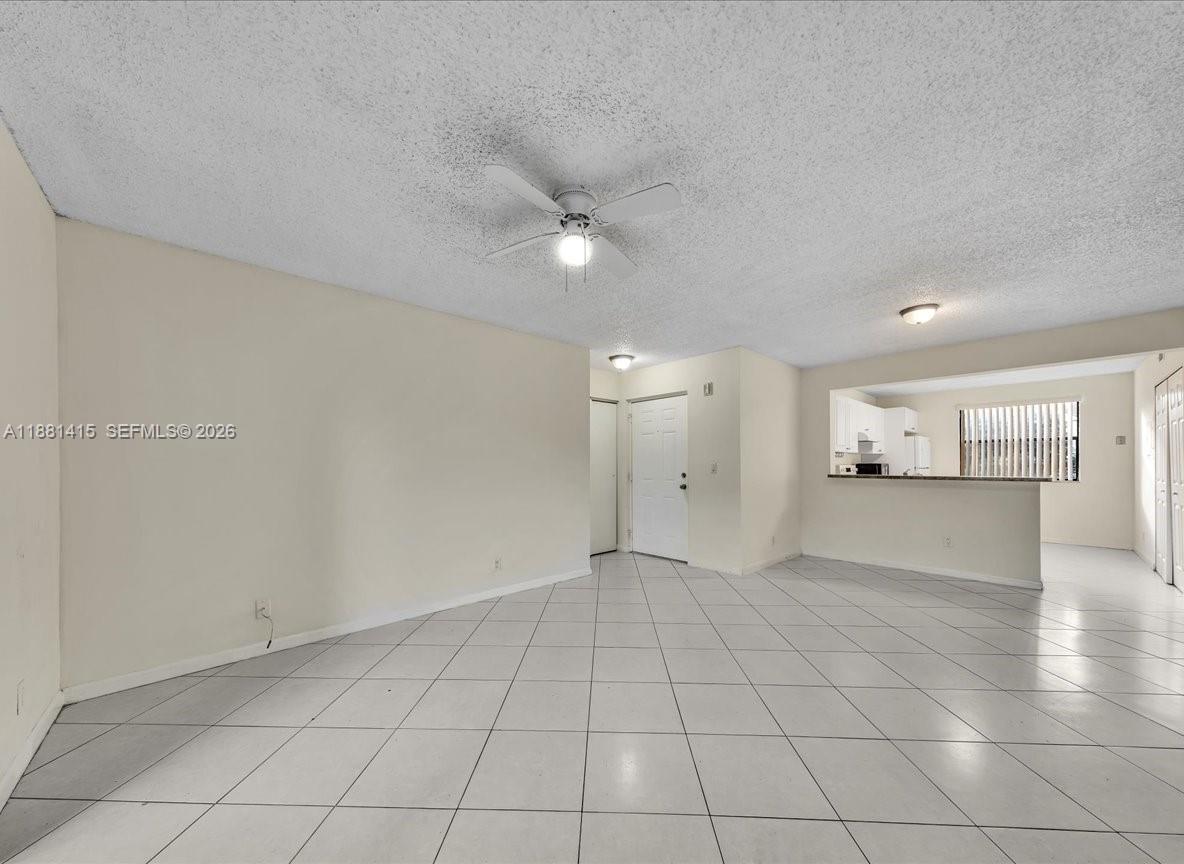 5661 Riverside Drive, Unit 101B7 Coral Springs, FL 33067 - Photo 12 of 49 an empty room with a empty space and windows