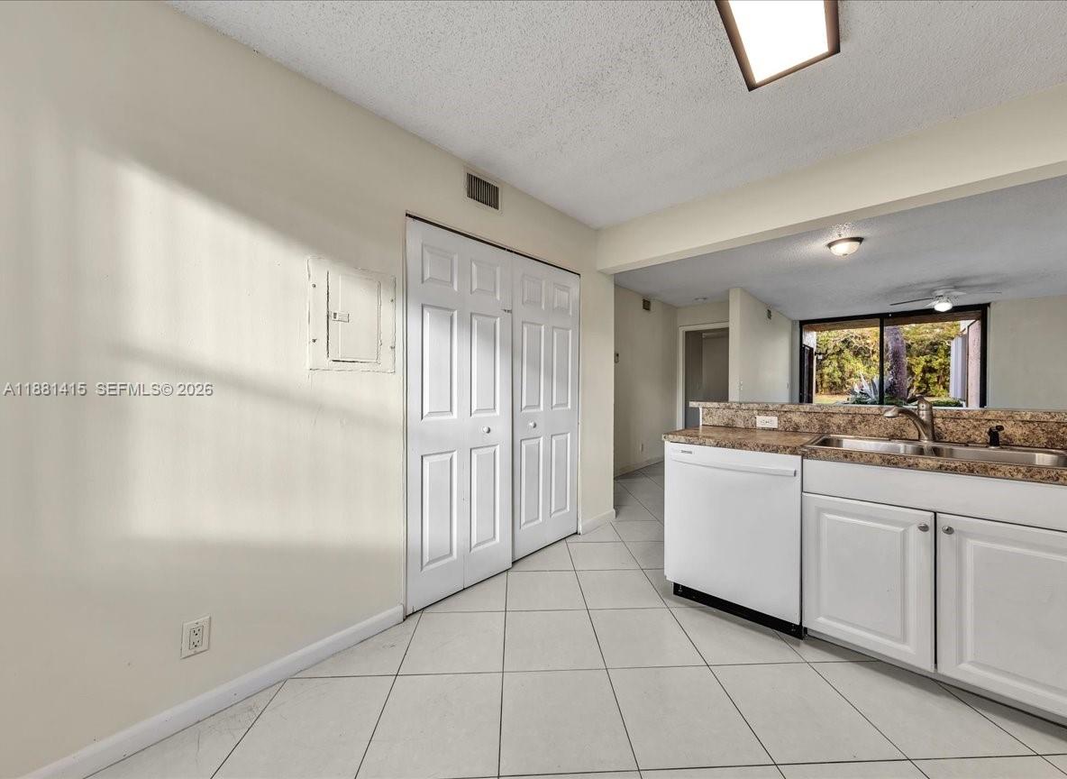 5661 Riverside Drive, Unit 101B7 Coral Springs, FL 33067 - Photo 17 of 49 a large white kitchen with white cabinets
