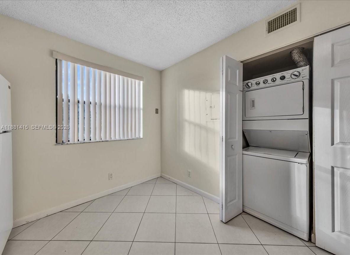 5661 Riverside Drive, Unit 101B7 Coral Springs, FL 33067 - Photo 19 of 49 a view of a storage & utility room with washer and dryer