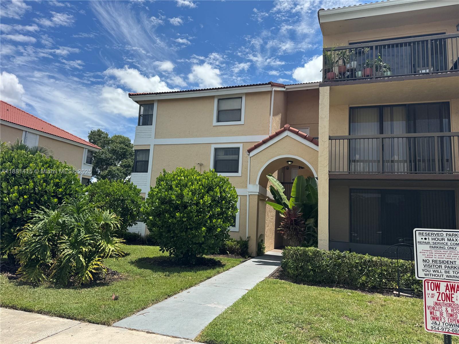 5661 Riverside Drive, Unit 101B7 Coral Springs, FL 33067 - Photo 2 of 60 a front view of a house with a garden