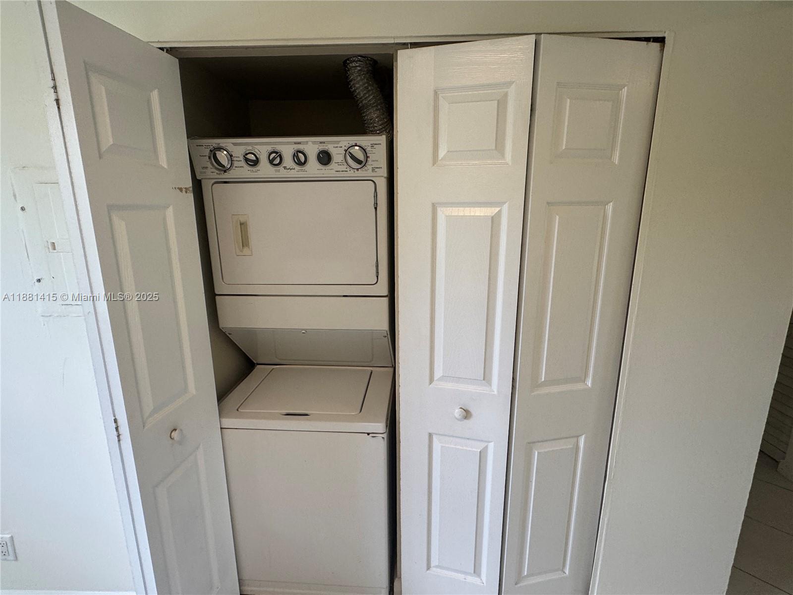 5661 Riverside Drive, Unit 101B7 Coral Springs, FL 33067 - Photo 22 of 60 a utility room with dryer and washer
