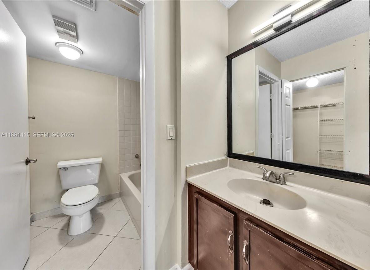 5661 Riverside Drive, Unit 101B7 Coral Springs, FL 33067 - Photo 26 of 49 a bathroom with a sink and a mirror