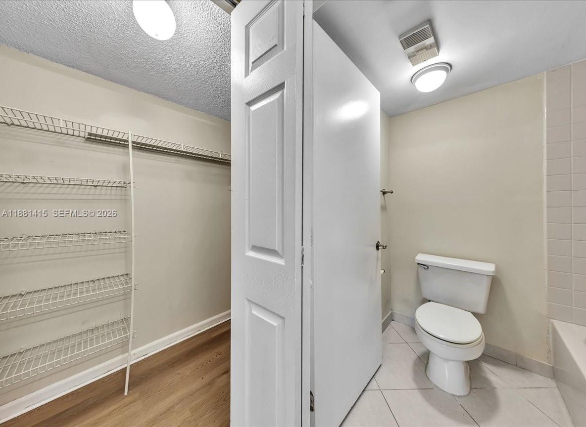 5661 Riverside Drive, Unit 101B7 Coral Springs, FL 33067 - Photo 27 of 49 a bathroom with a toilet and a shower