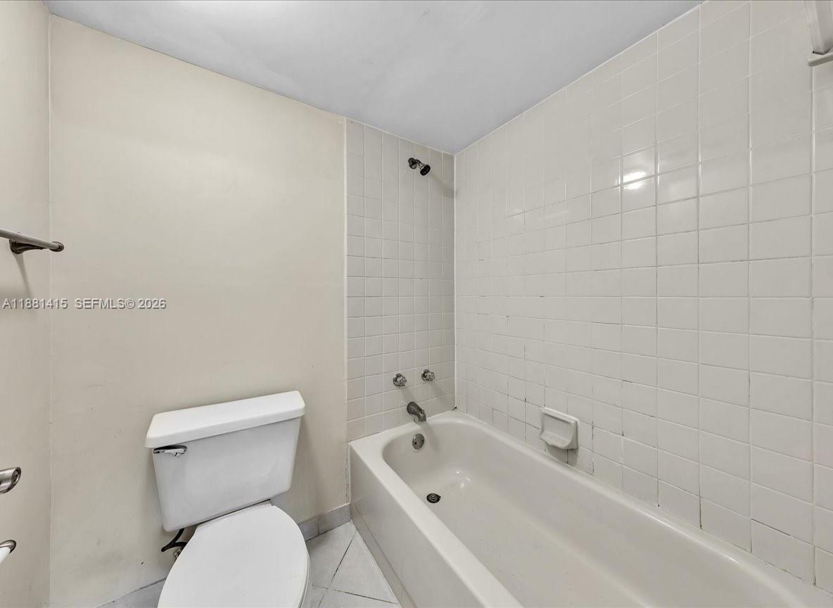 5661 Riverside Drive, Unit 101B7 Coral Springs, FL 33067 - Photo 29 of 49 a white toilet sitting next to a bath tub
