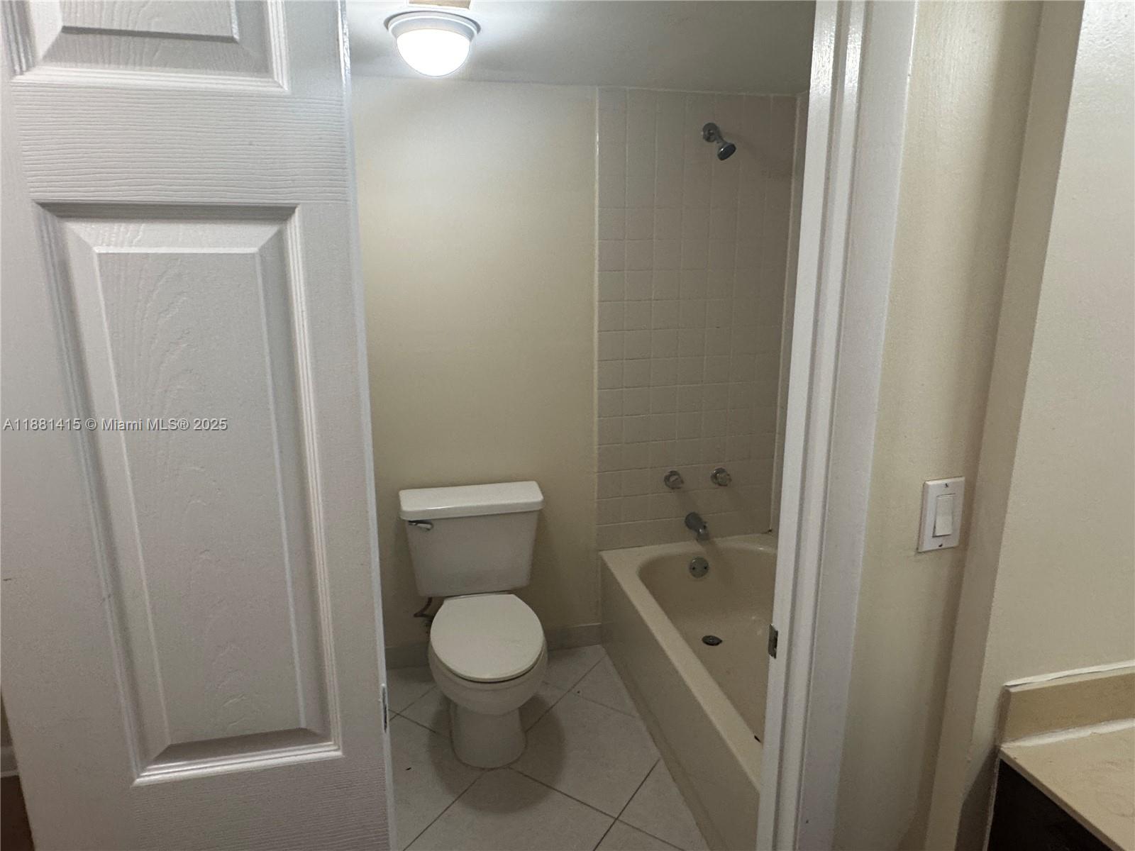 5661 Riverside Drive, Unit 101B7 Coral Springs, FL 33067 - Photo 30 of 60 a bathroom with a toilet and a sink