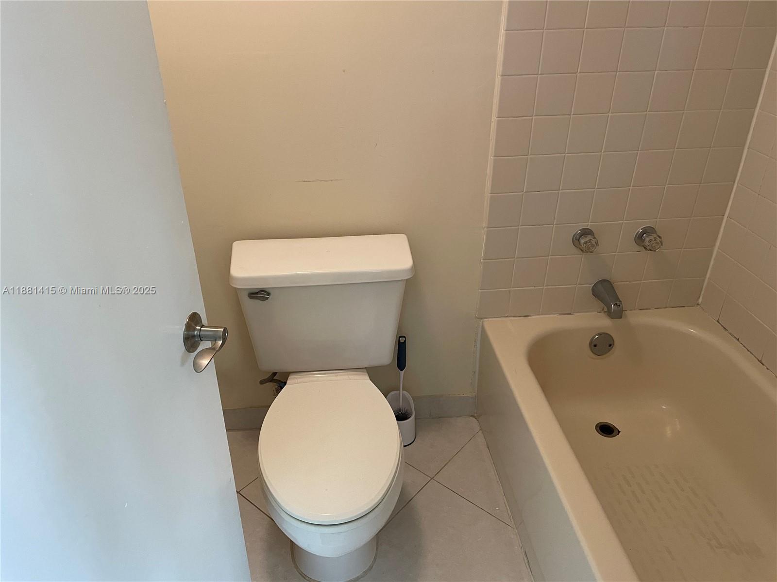5661 Riverside Drive, Unit 101B7 Coral Springs, FL 33067 - Photo 31 of 60 a white toilet sitting next to a white sink