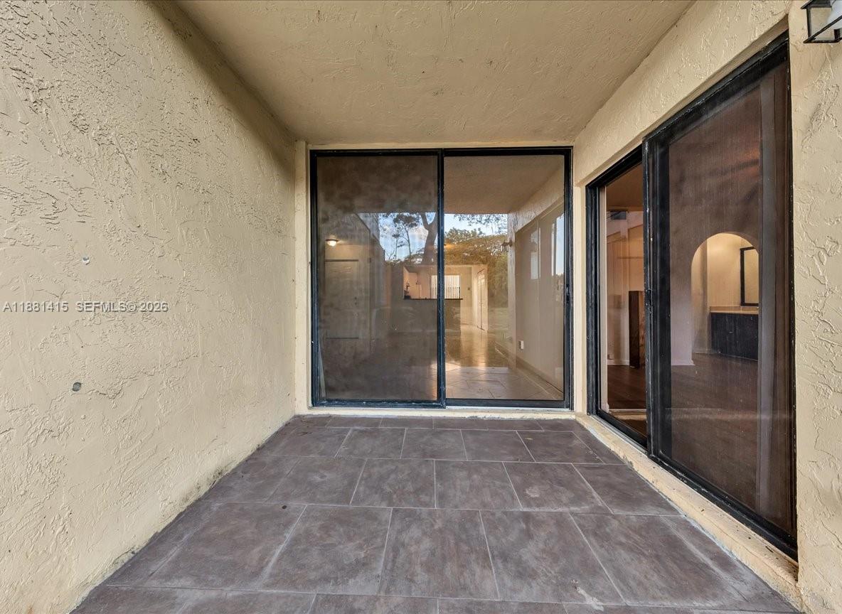 5661 Riverside Drive, Unit 101B7 Coral Springs, FL 33067 - Photo 32 of 49 a view of a glass entrance door of the house