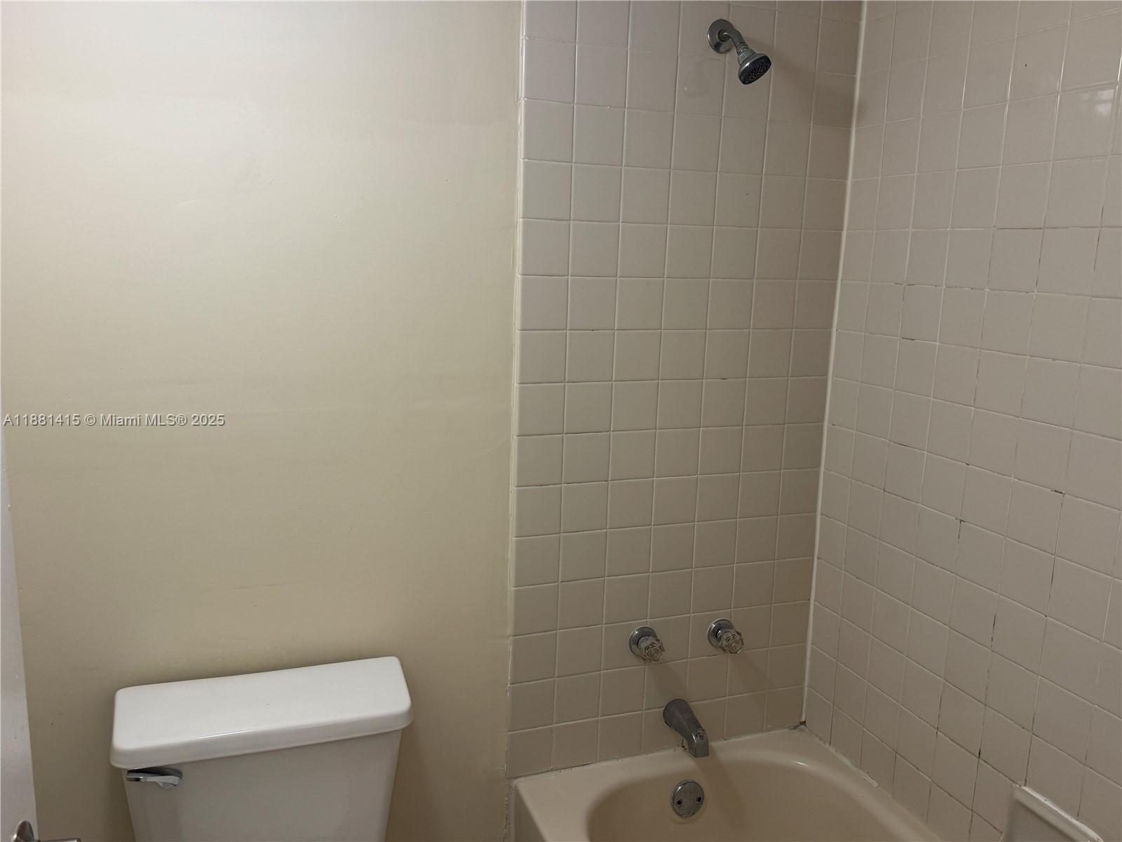 5661 Riverside Drive, Unit 101B7 Coral Springs, FL 33067 - Photo 32 of 60 a white toilet sitting next to a bath tub