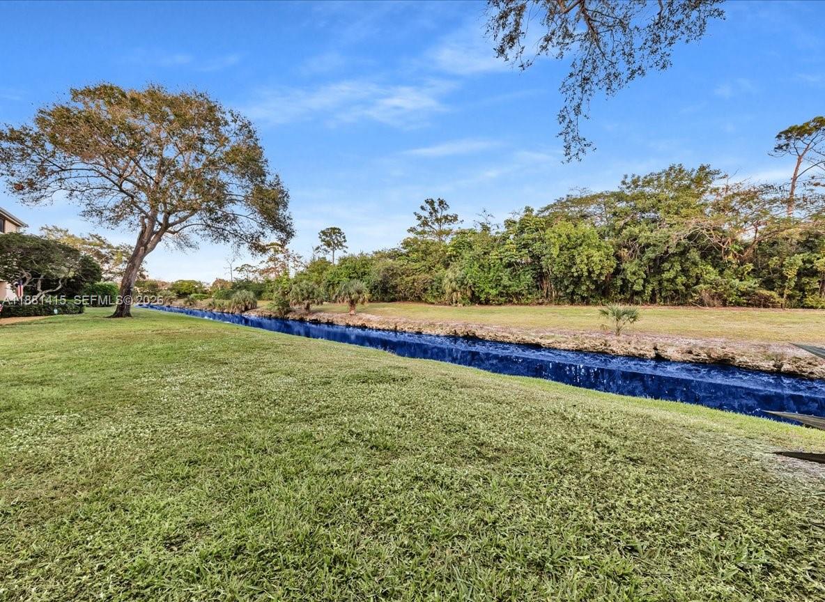 5661 Riverside Drive, Unit 101B7 Coral Springs, FL 33067 - Photo 33 of 49 a view of an outdoor space with a lake view
