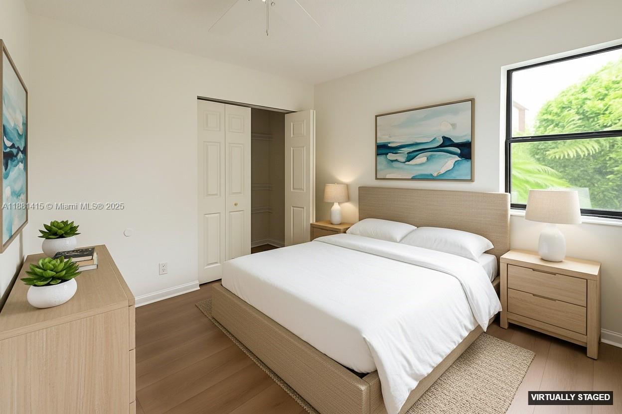 5661 Riverside Drive, Unit 101B7 Coral Springs, FL 33067 - Photo 33 of 60 a bedroom with a bed and a painting on the wall