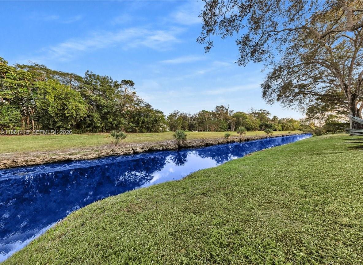 5661 Riverside Drive, Unit 101B7 Coral Springs, FL 33067 - Photo 35 of 49 a view of a lake with outdoor space