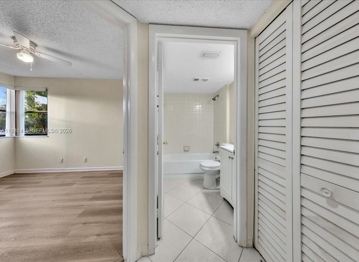5661 Riverside Drive, Unit 101B7 Coral Springs, FL 33067 - Photo 36 of 49 a bathroom with a toilet