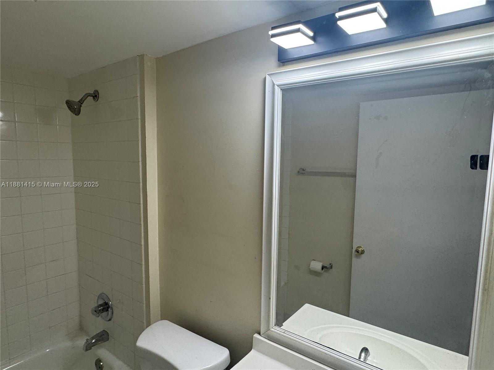 5661 Riverside Drive, Unit 101B7 Coral Springs, FL 33067 - Photo 37 of 60 a bathroom with a toilet and a shower