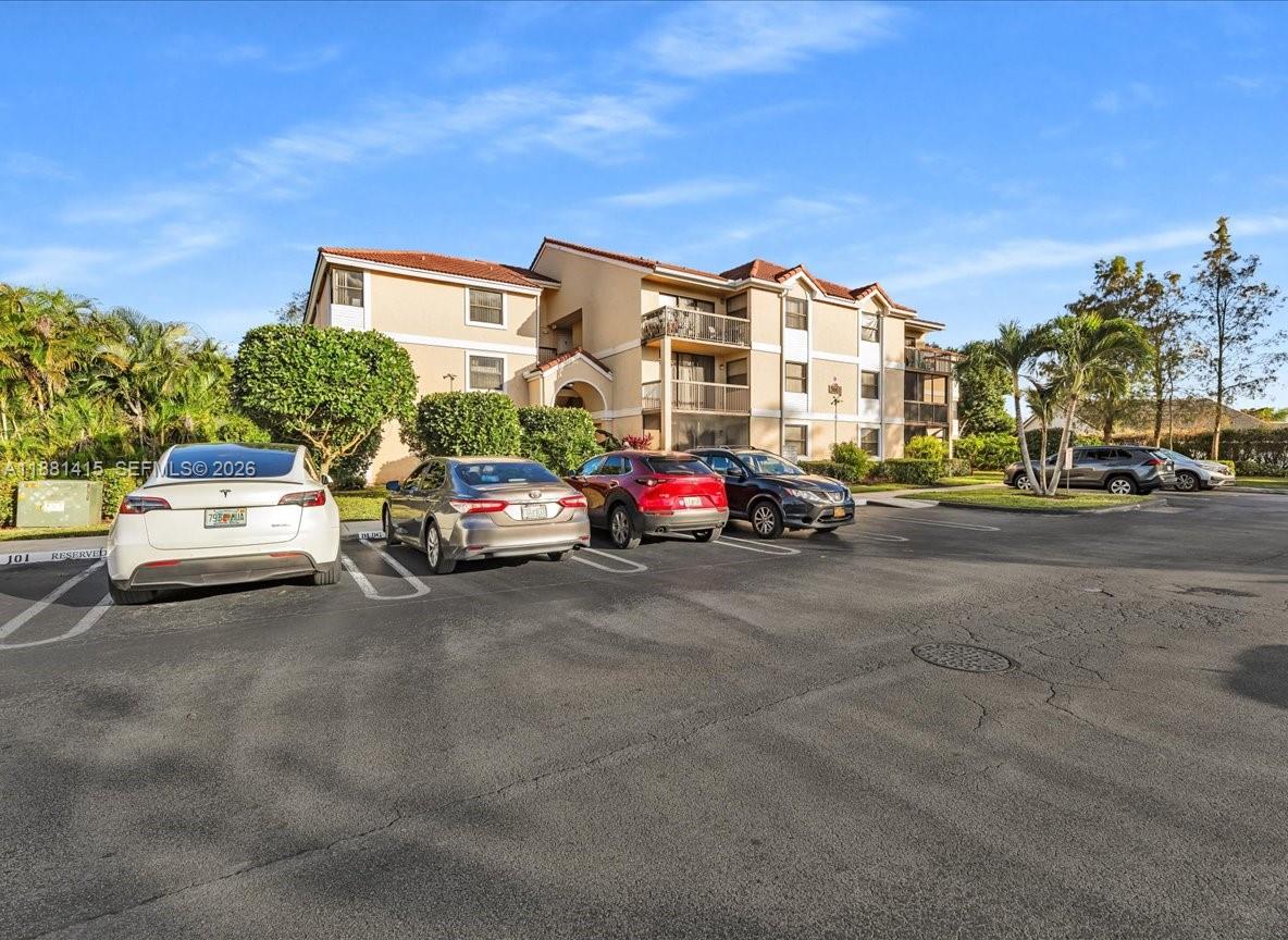 5661 Riverside Drive, Unit 101B7 Coral Springs, FL 33067 - Photo 4 of 49 a car parked in front of a house