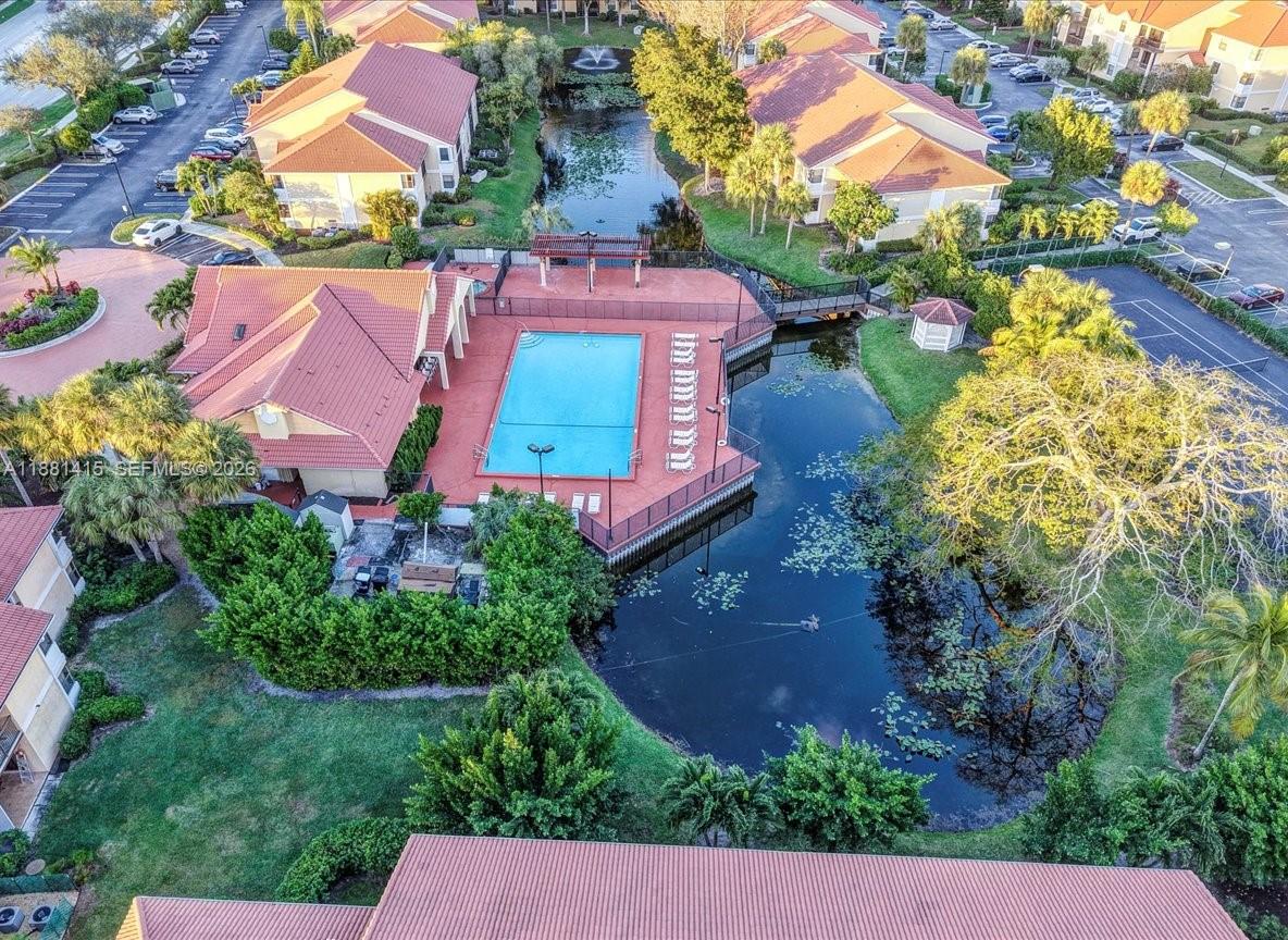 5661 Riverside Drive, Unit 101B7 Coral Springs, FL 33067 - Photo 42 of 49 an aerial view of house with yard swimming pool and outdoor seating