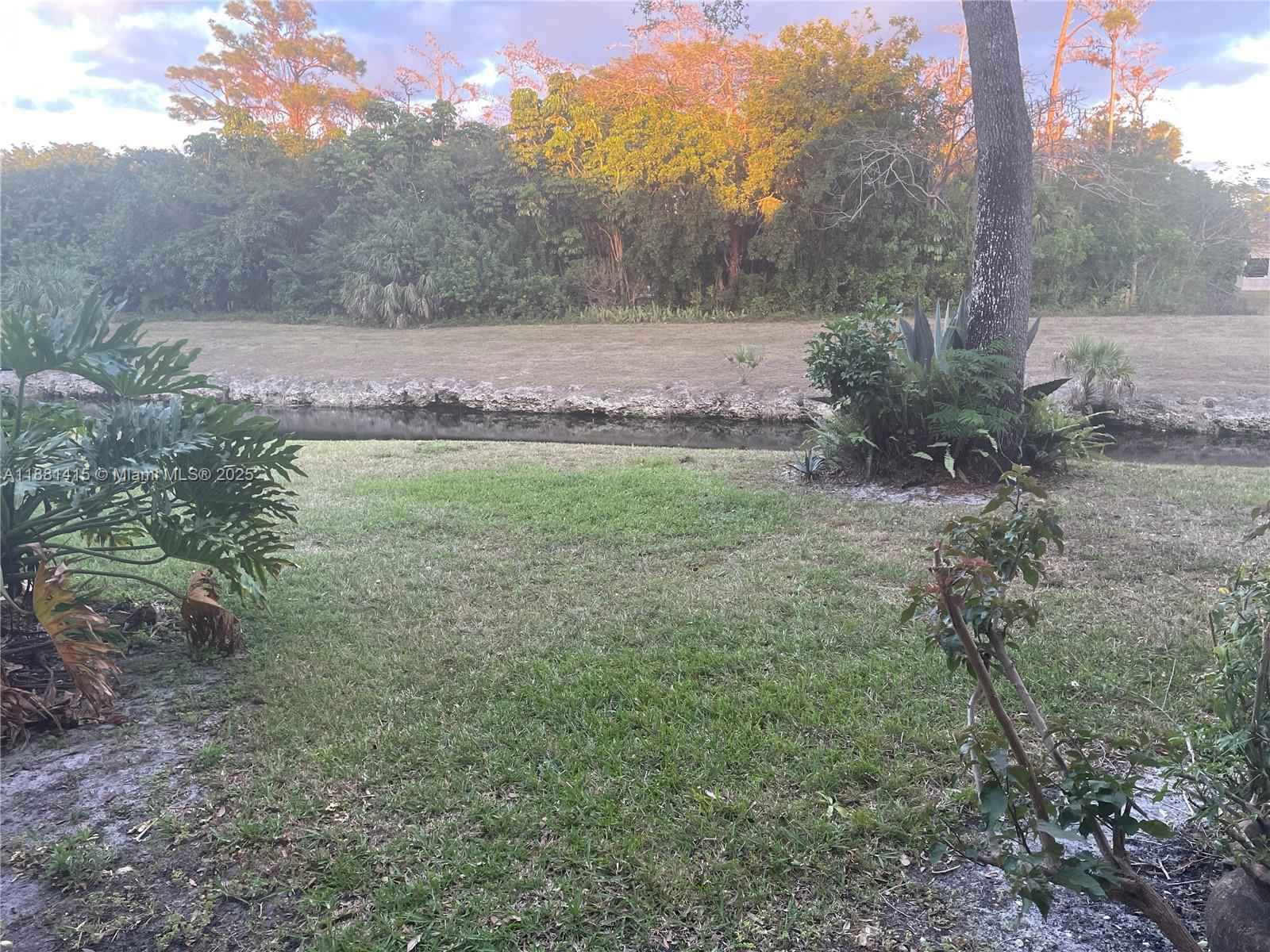 5661 Riverside Drive, Unit 101B7 Coral Springs, FL 33067 - Photo 49 of 60 a view of a large yard with lots of green space