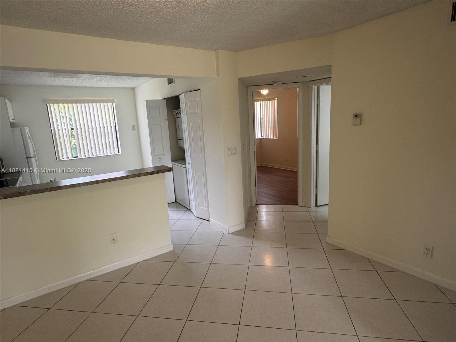 5661 Riverside Drive, Unit 101B7 Coral Springs, FL 33067 - Photo 5 of 60 a view of an empty room with window and bathroom