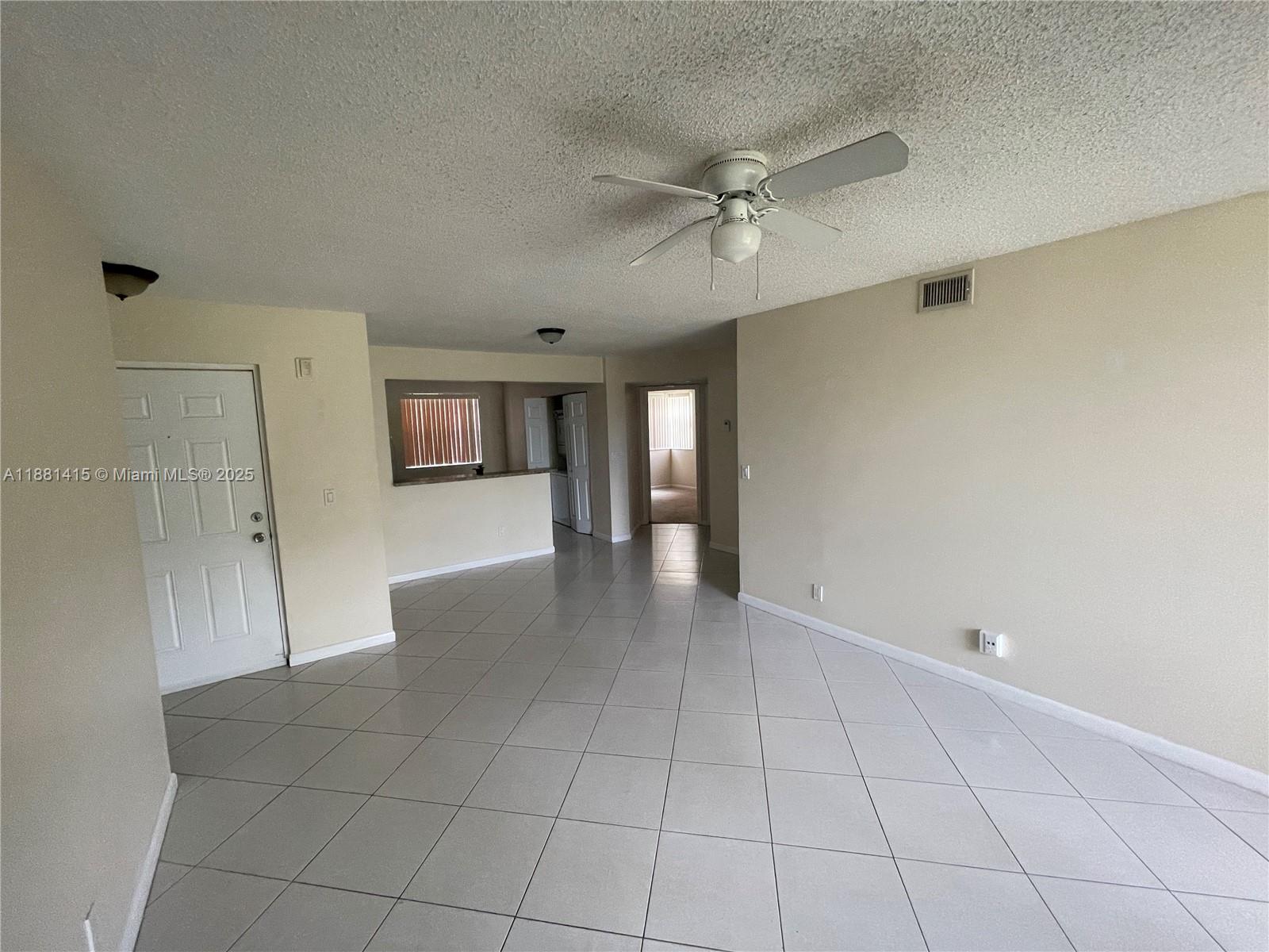 5661 Riverside Drive, Unit 101B7 Coral Springs, FL 33067 - Photo 7 of 60 a view of an empty room with a window