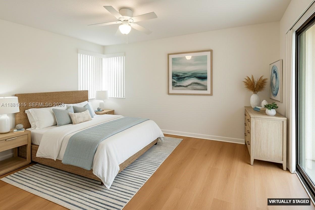 5661 Riverside Drive, Unit 101B7 Coral Springs, FL 33067 - Photo 7 of 49 a bedroom with a bed and a chandelier