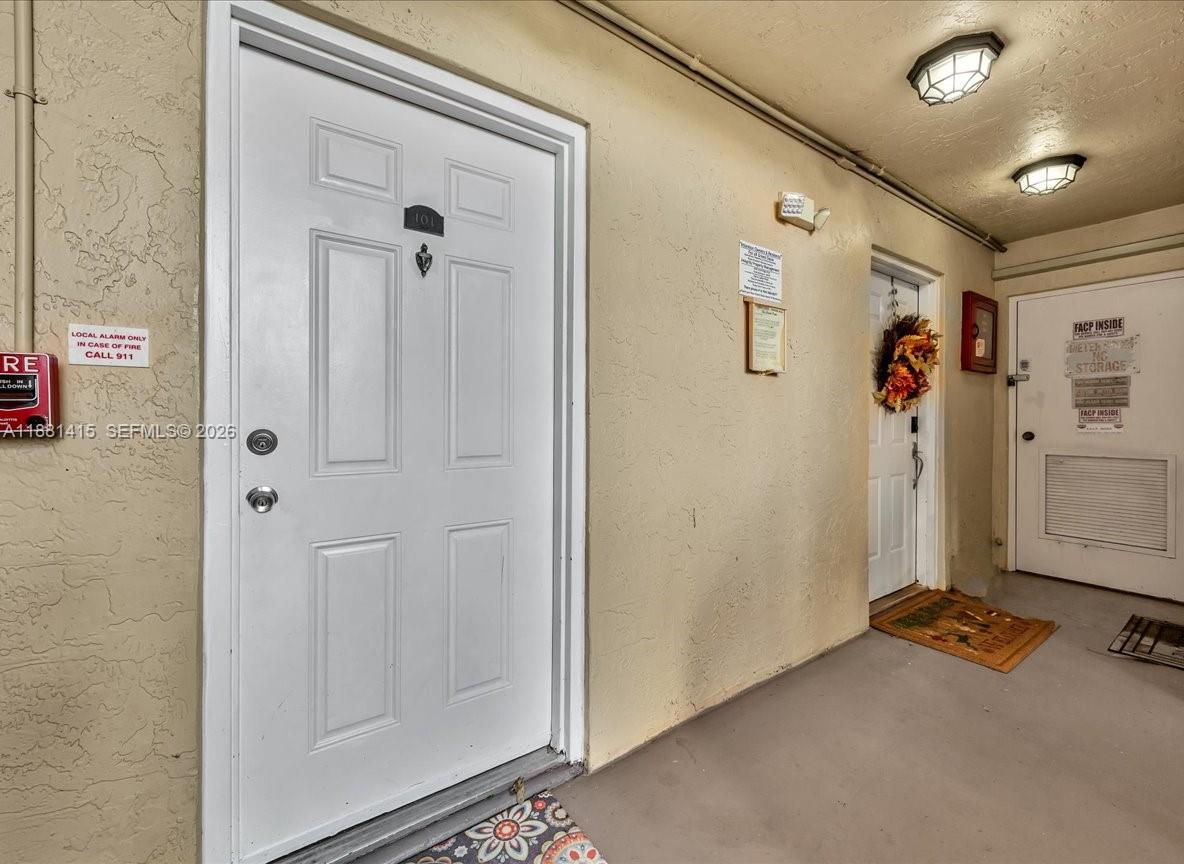 5661 Riverside Drive, Unit 101B7 Coral Springs, FL 33067 - Photo 9 of 49 a view of a livingroom with wooden floor and closet area