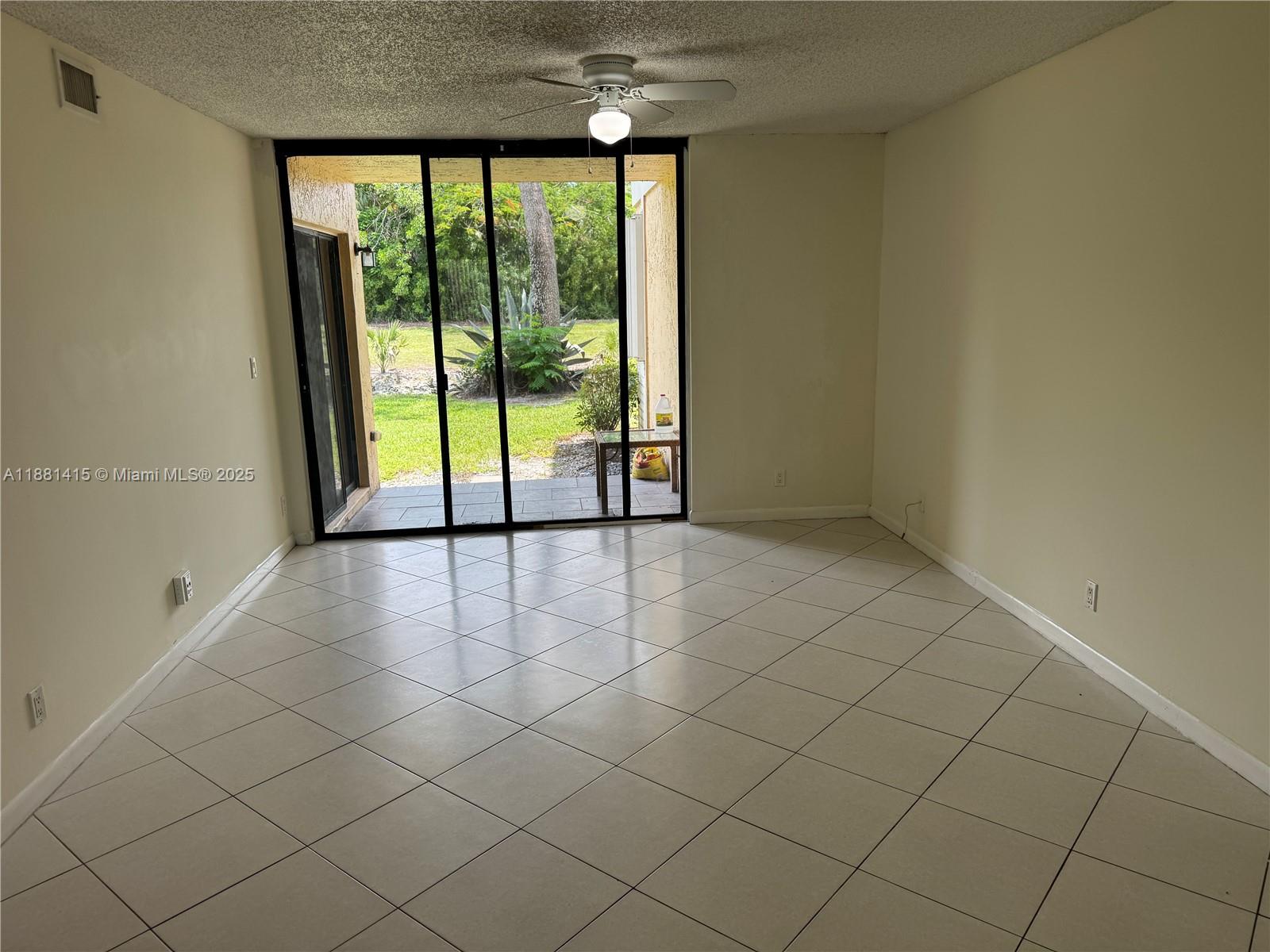 5661 Riverside Drive, Unit 101B7 Coral Springs, FL 33067 - Photo 9 of 60 a view of an empty room and window
