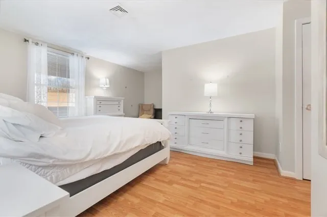 a large white bed in a white room