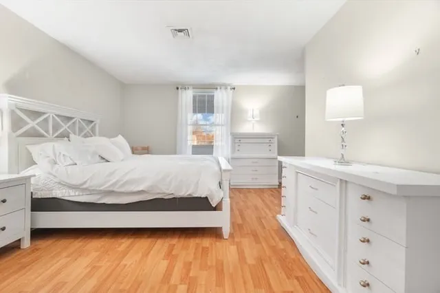 a bedroom with a bed and a dresser