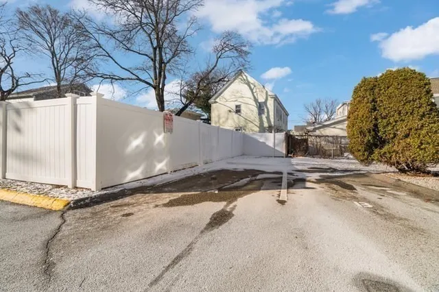 a backyard of a house with table and chairs