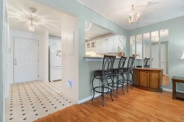 a view of a dining room with furniture and wooden floor