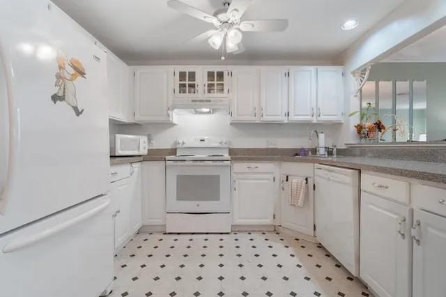 a kitchen with a stove a sink and a refrigerator