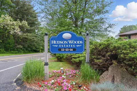 a sign that is sitting in front of flowers