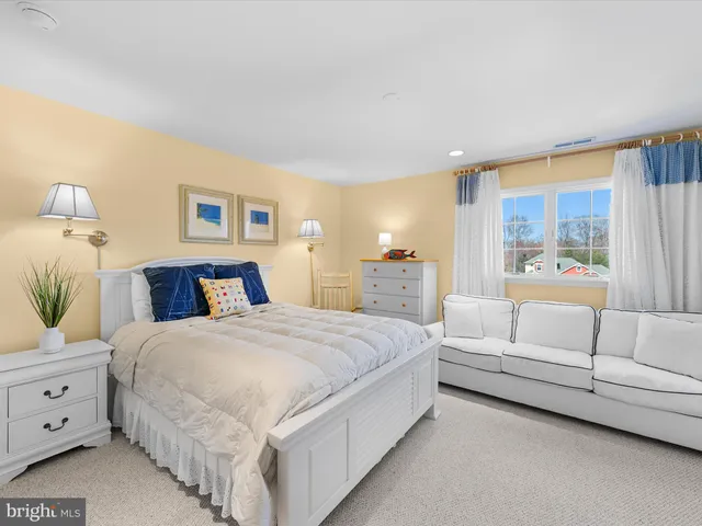 a bedroom with a large bed and a dresser