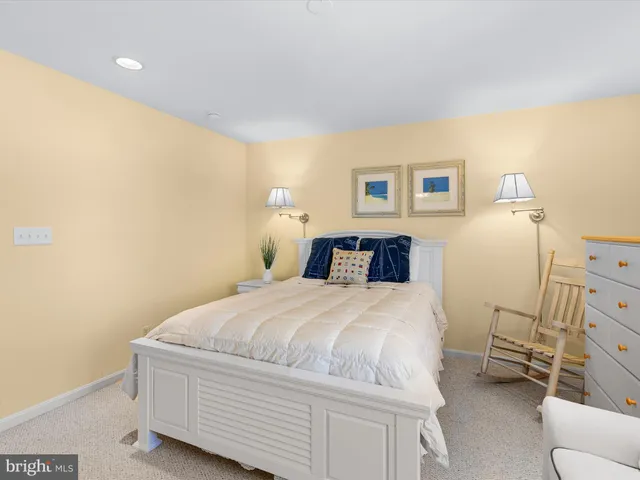 a bedroom with a bed a dresser and a window