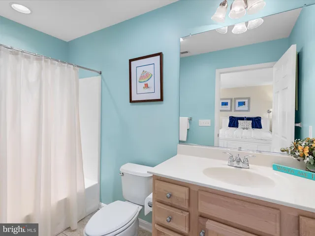 a bedroom with a bed a mirror and a window