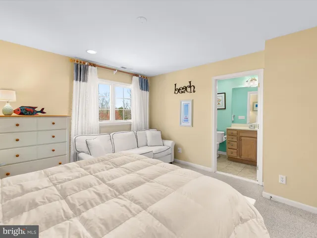 a bedroom with a bed and a view of bathroom