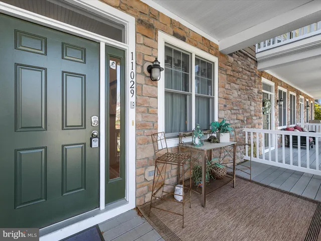 a view of a house with a porch and furniture