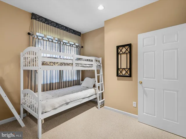 a bedroom with furniture and baby crib