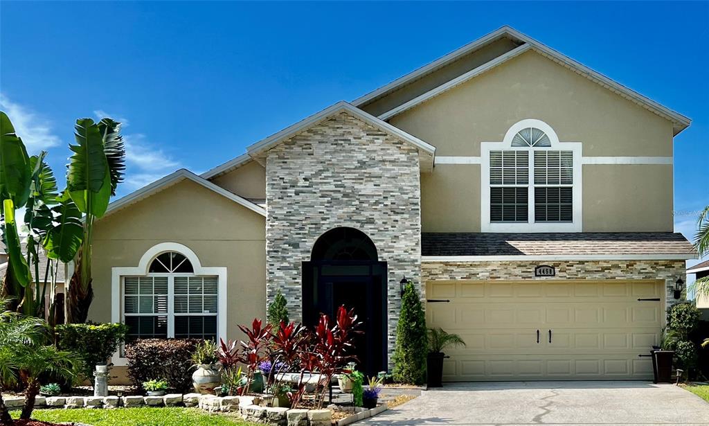 a front view of a house with a garden