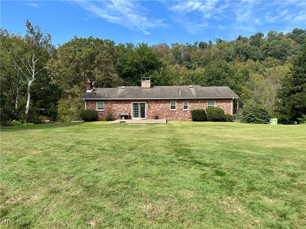 4461 Cross Creek Road Colliers, WV 26035 - Photo 26 of 33 Back of property with a yard, a patio area, and brick siding