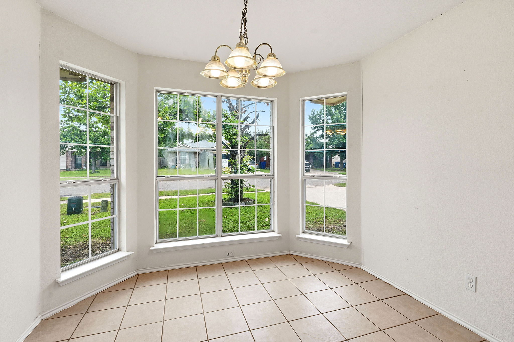 116 Blue Ridge Trail Elgin, TX 78621 - Photo 13 of 28 a view of an empty room with windows and chandelier