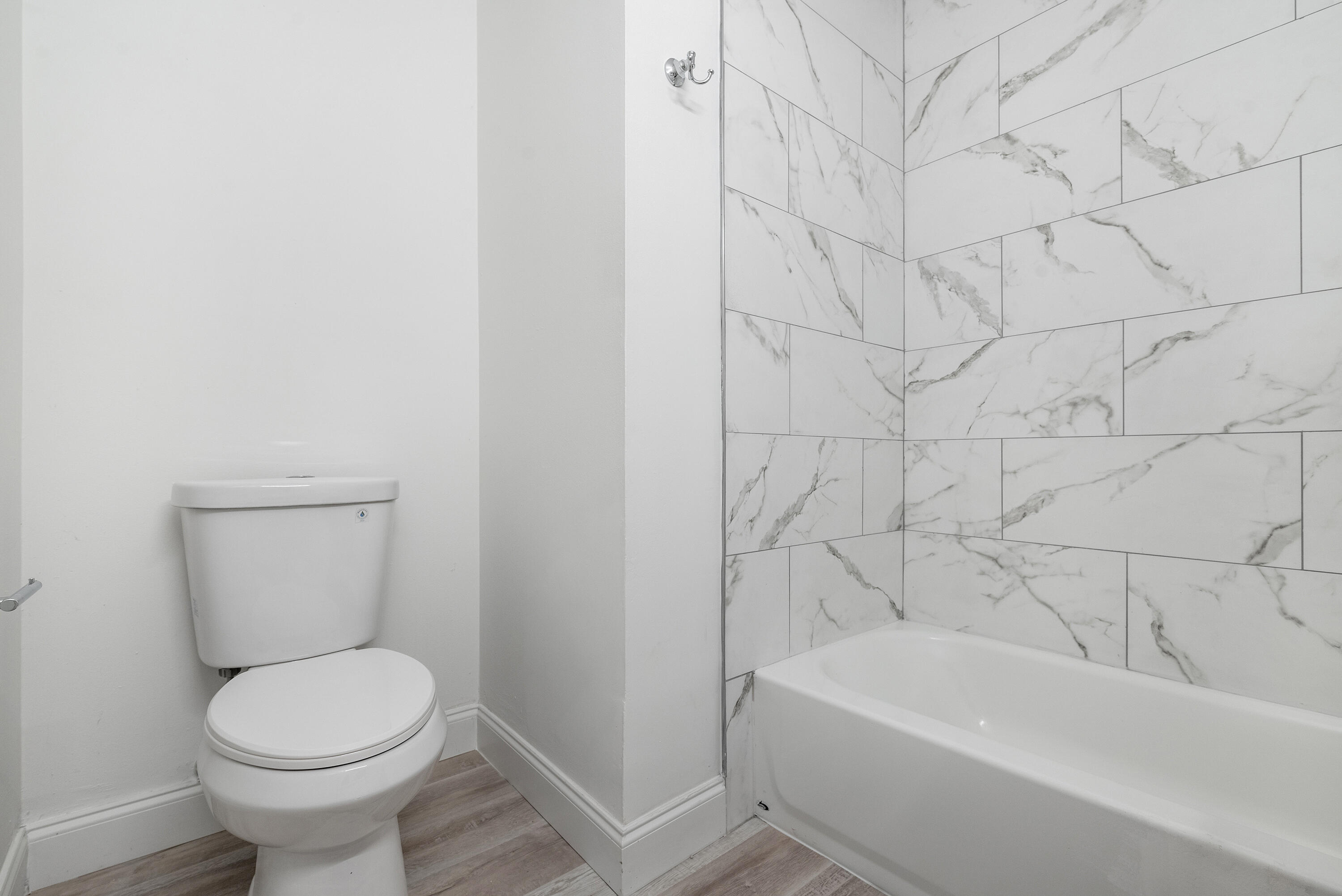 5629 Southeast Collins Avenue Stuart, FL 34997 - Photo 11 of 39 a bathroom with a toilet and a bathtub
