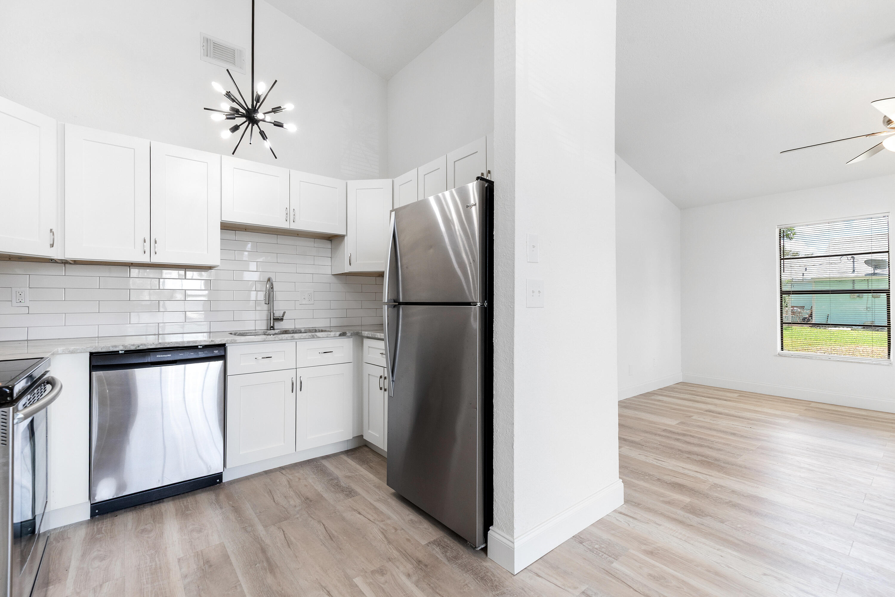 5629 Southeast Collins Avenue Stuart, FL 34997 - Photo 16 of 39 a kitchen with stainless steel appliances granite countertop a refrigerator a sink and a stove