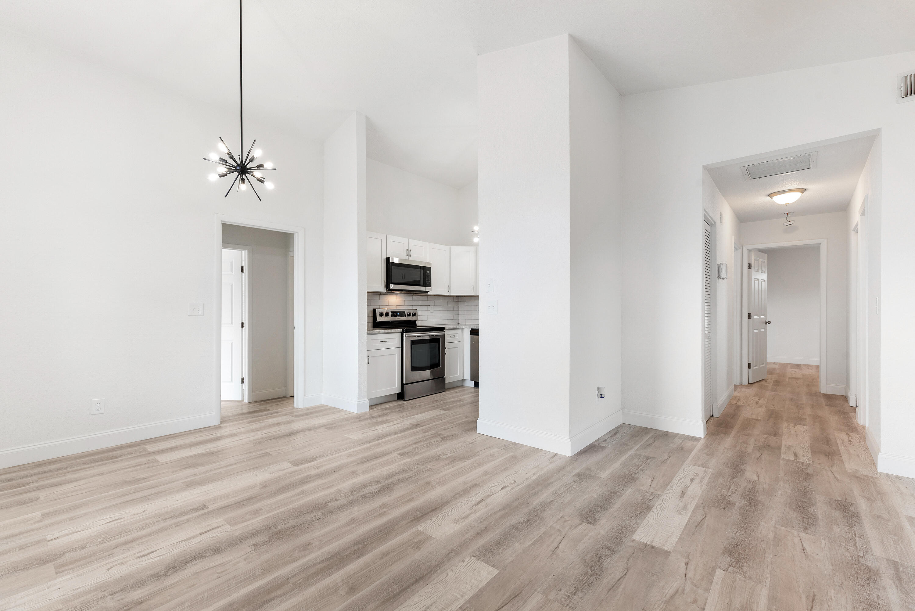 5629 Southeast Collins Avenue Stuart, FL 34997 - Photo 20 of 39 a view of a kitchen with wooden floor and a sink