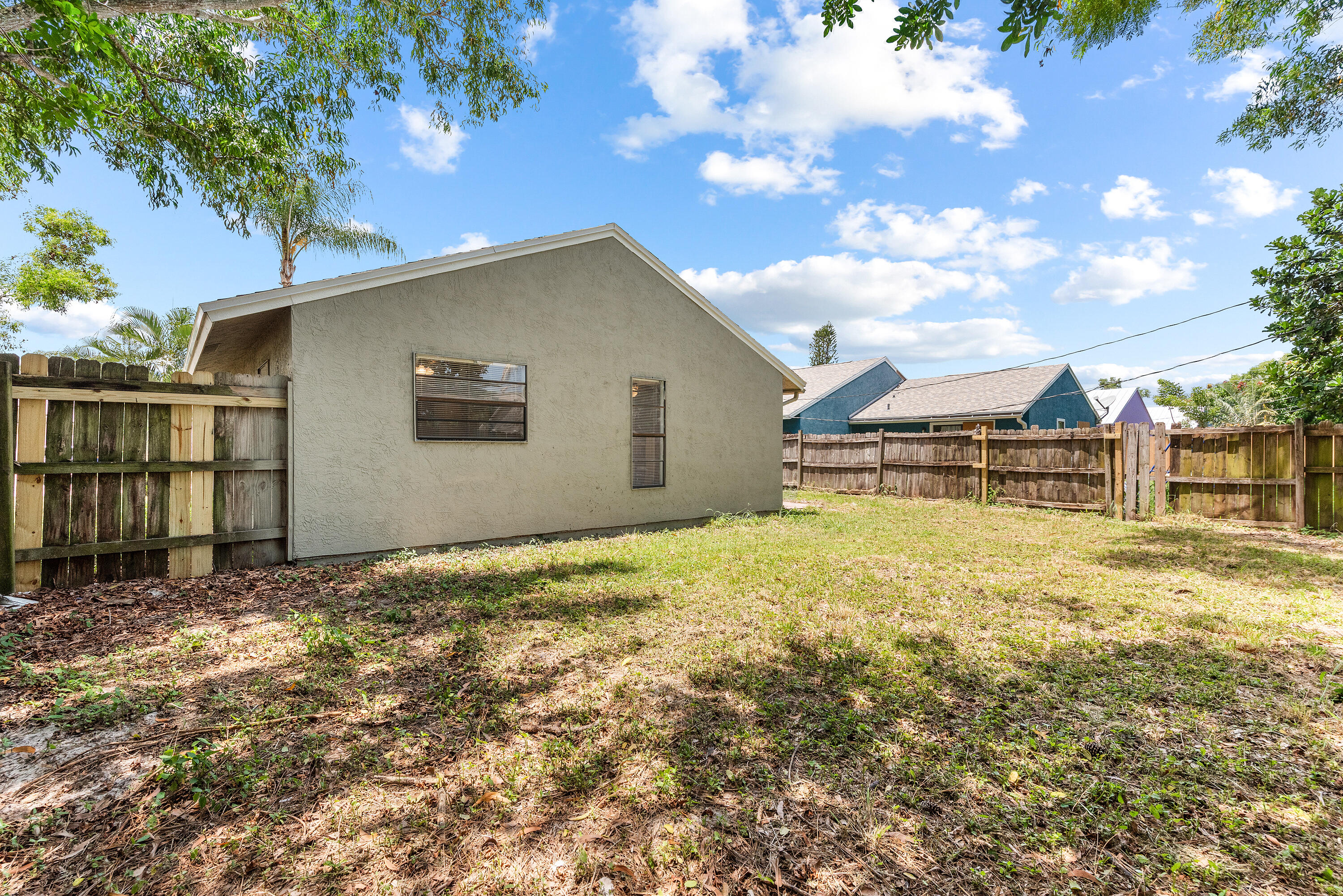 5629 Southeast Collins Avenue Stuart, FL 34997 - Photo 26 of 39 a view of a house with a yard