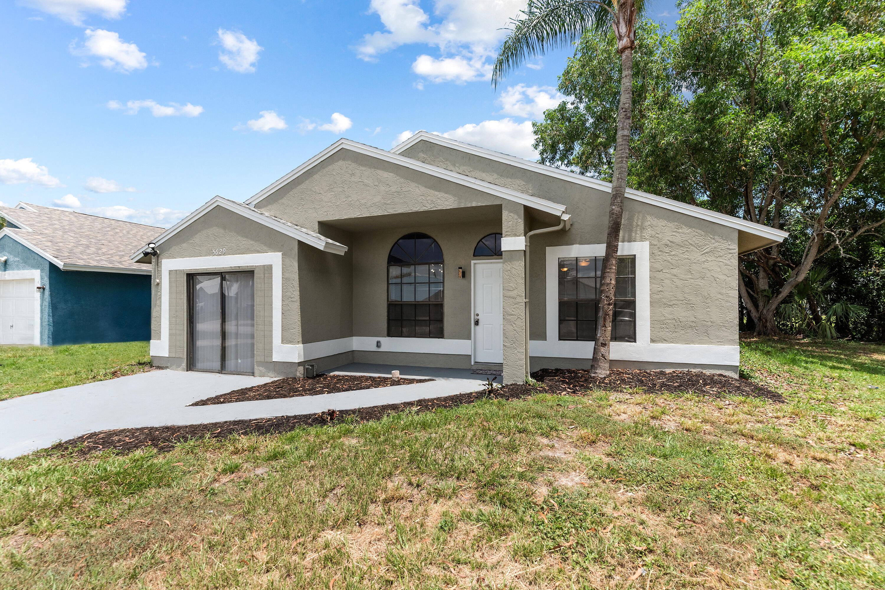 5629 Southeast Collins Avenue Stuart, FL 34997 - Photo 37 of 39 a view of a house with a yard and large tree