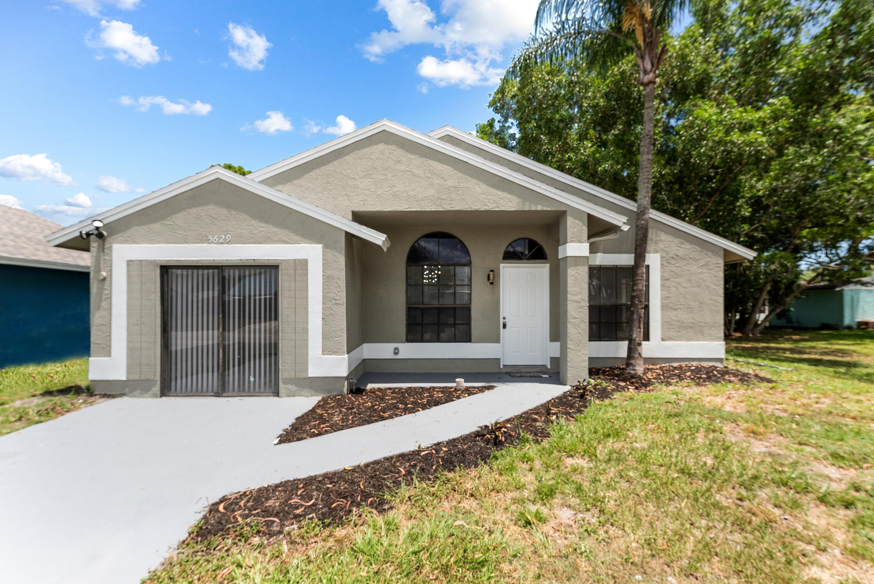 5629 Southeast Collins Avenue Stuart, FL 34997 - Photo 39 of 39 a front view of a house with a yard