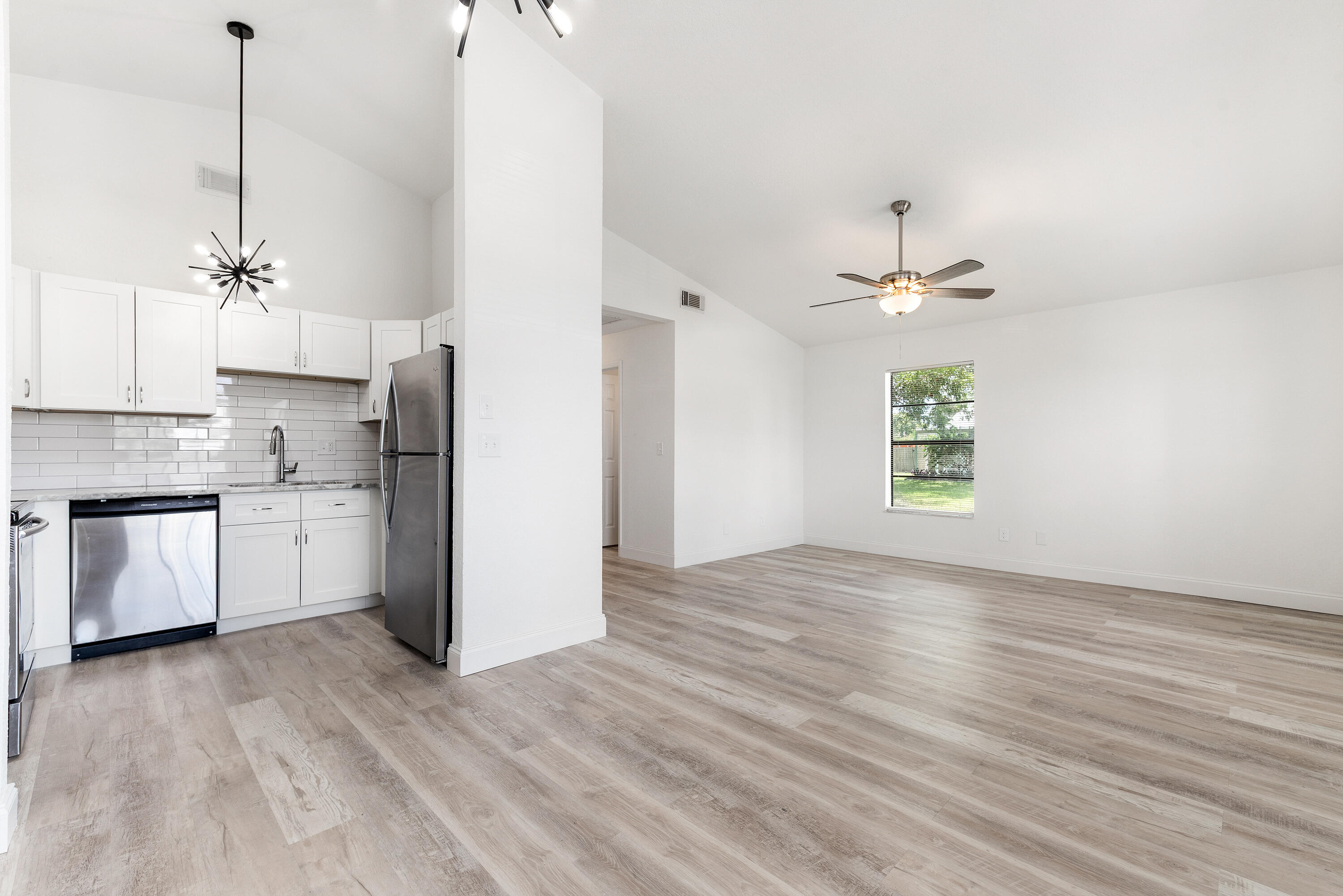5629 Southeast Collins Avenue Stuart, FL 34997 - Photo 5 of 39 a view of a kitchen with a sink cabinets and wooden floor